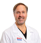 Christopher Caulfield, MD at HealthTexas in a white lab coat