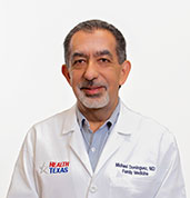 Michael Dominguez, MD at HealthTexas in white lab coat