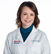 Lauren Bishop, MD at HealthTexas. Featured in a white coat