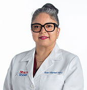 Rose Villarreal FNP-C in white coat at HealthTexas