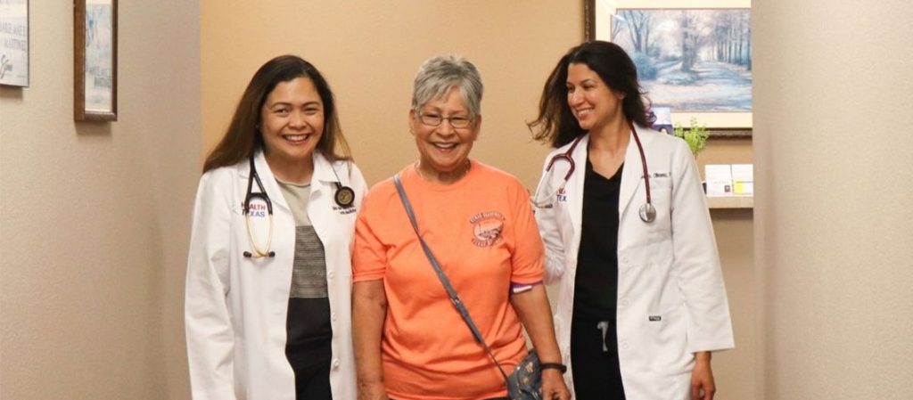 elderly patient in between 2 HealthTexas doctors